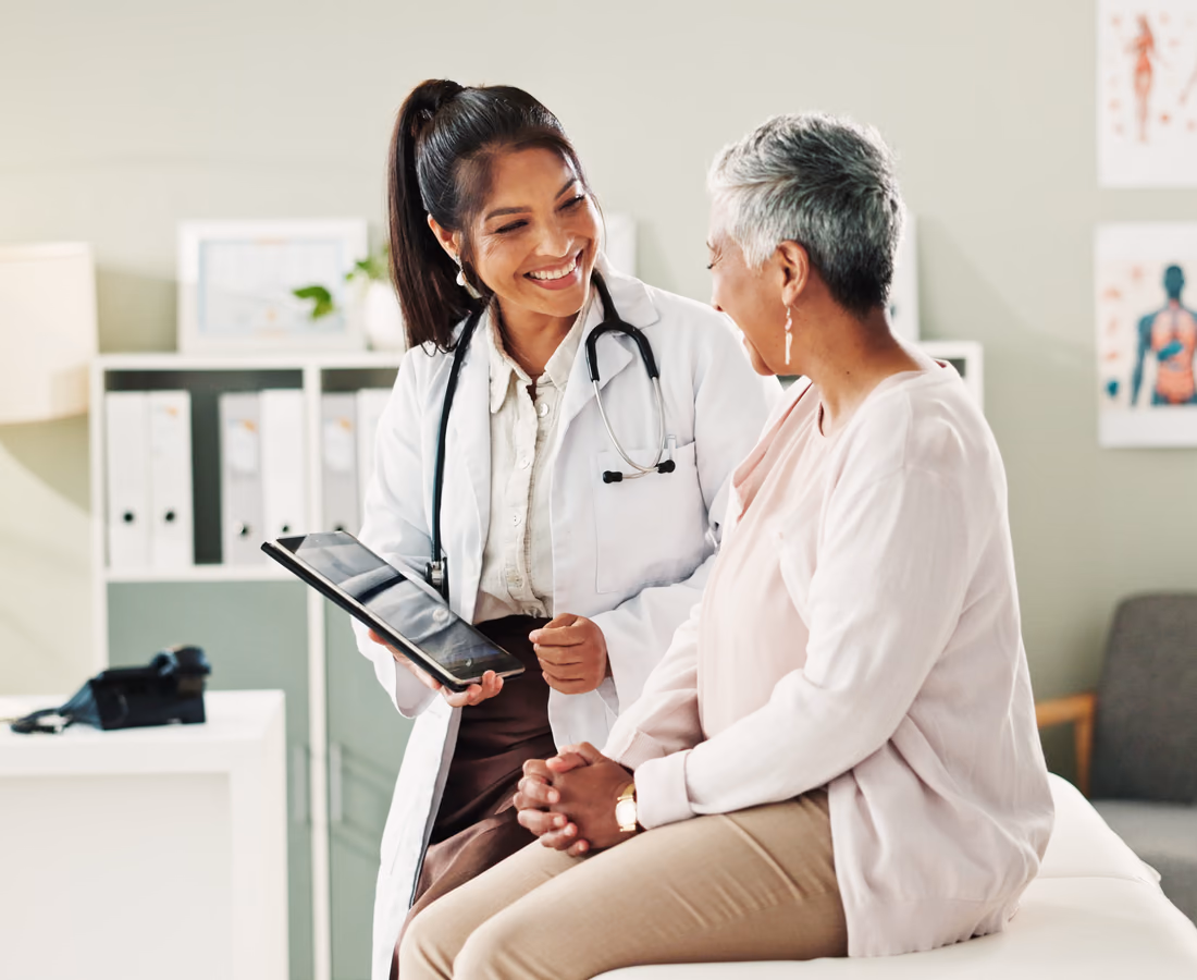 Clinical staff talking in a hospital lobby